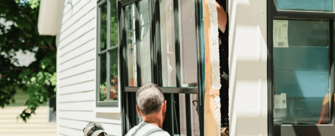 two men installing a pella window on a home